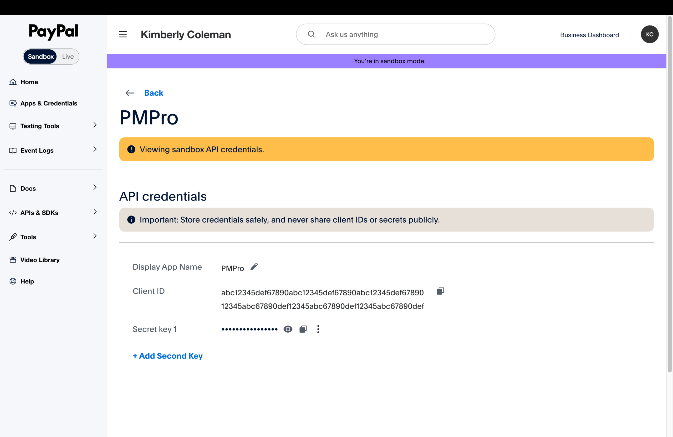 PayPal Developer Dashboard sandbox app detail page for the PMPro app, showing the API credentials section with a masked Client ID and a masked Secret key. The page indicates sandbox mode.