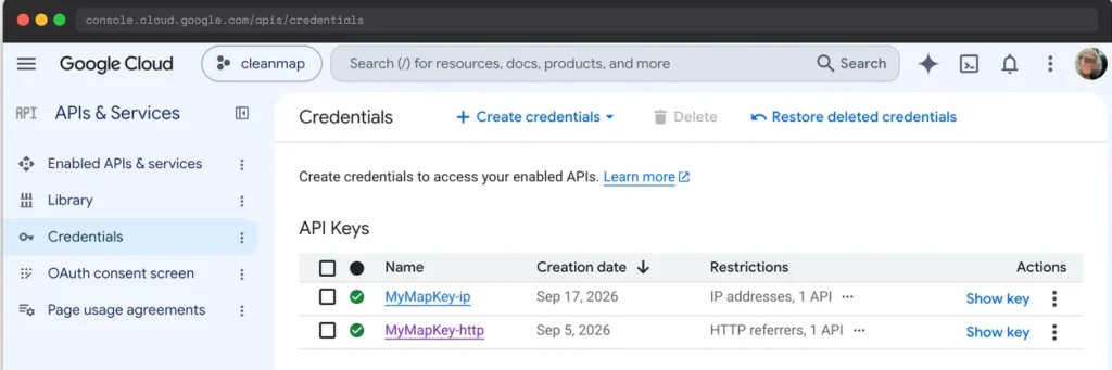 Google Cloud Credentials page showing two API keys: one restricted by IP addresses for geocoding, one restricted by HTTP referrers for the JavaScript Maps API